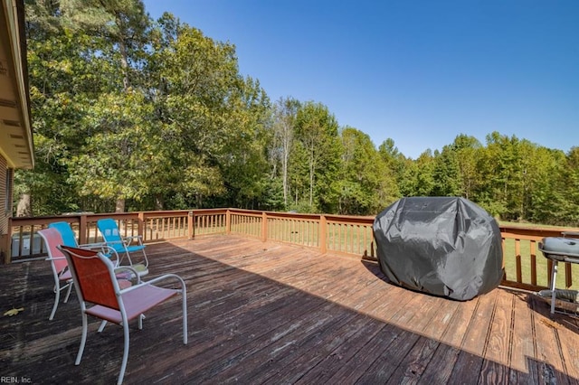 wooden deck with a grill