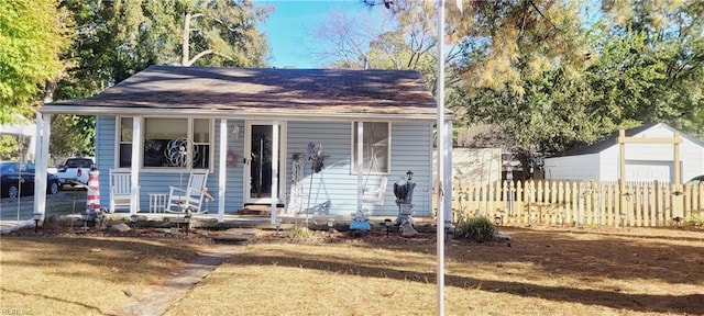 bungalow-style house featuring a front yard and covered porch