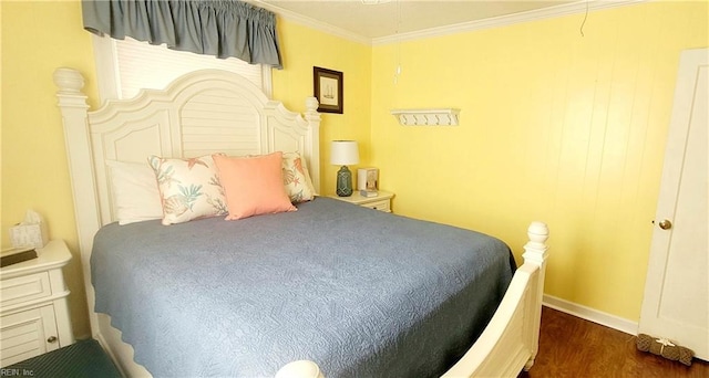 bedroom with ornamental molding and dark hardwood / wood-style floors