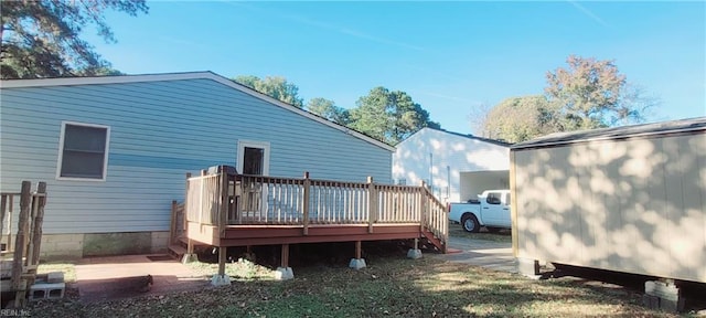 rear view of house featuring a wooden deck