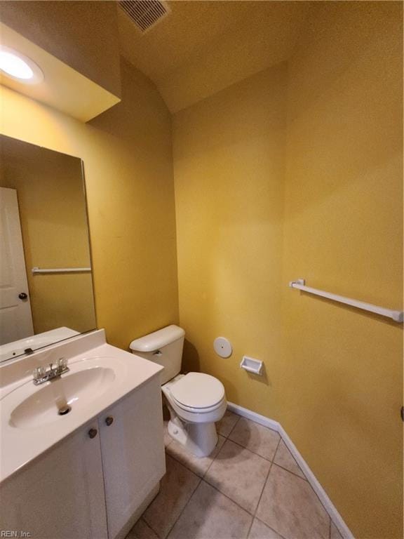 bathroom with vanity, a textured ceiling, toilet, and tile patterned flooring