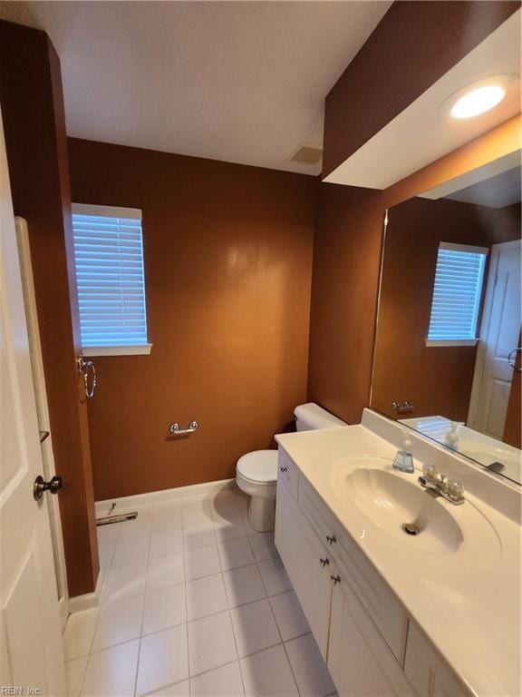 bathroom featuring vanity, toilet, and tile patterned floors