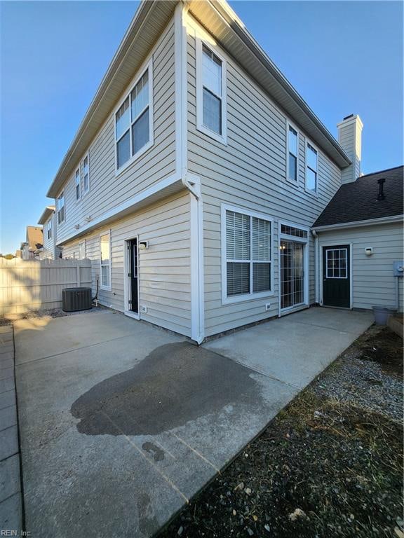 rear view of property with central AC and a patio