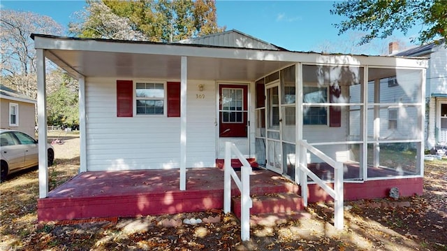 view of front of property featuring a sunroom