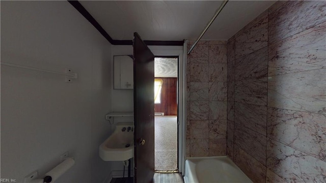 bathroom featuring tiled shower / bath and toilet