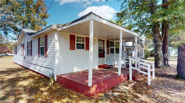 view of front of home with a deck and a sunroom