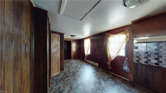 interior space featuring a baseboard heating unit and wood walls