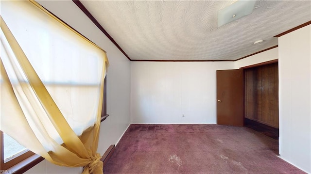 unfurnished bedroom with carpet, a textured ceiling, and ornamental molding