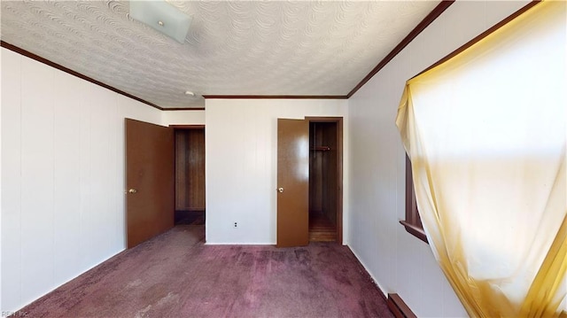 unfurnished bedroom featuring crown molding, a textured ceiling, and carpet