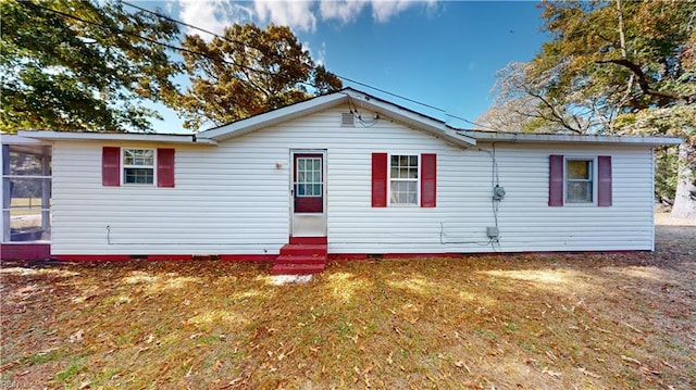 back of property featuring a lawn