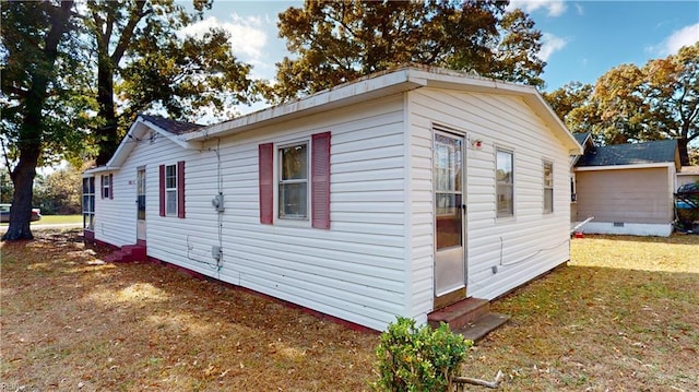 view of home's exterior with a yard