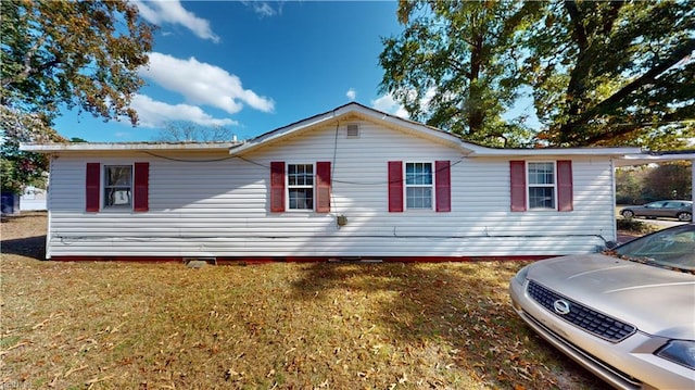 view of side of home featuring a lawn