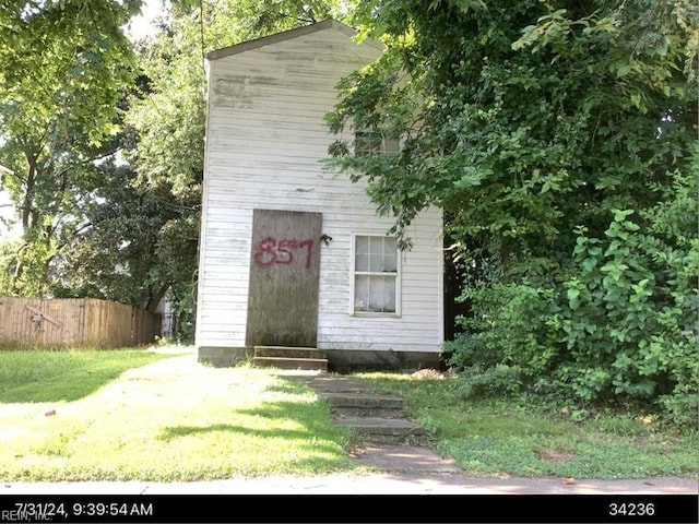 view of outbuilding featuring a yard