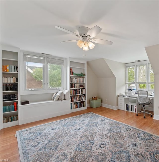 office featuring ceiling fan, light wood-type flooring, and plenty of natural light