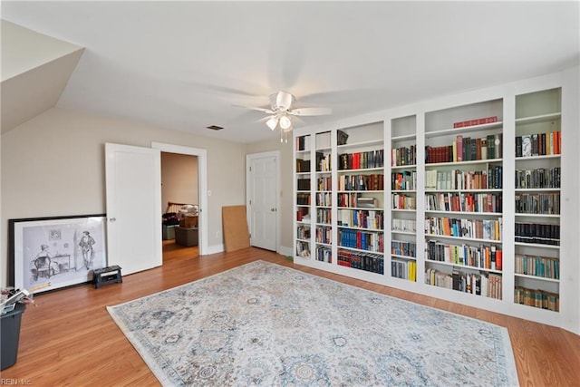 sitting room with wood-type flooring, vaulted ceiling, and ceiling fan