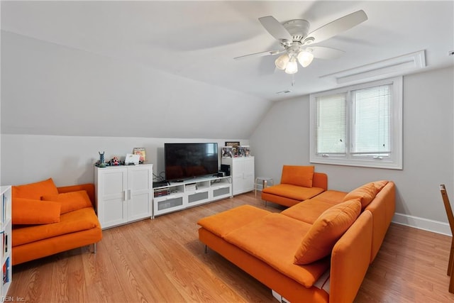 living room featuring ceiling fan, light wood-type flooring, and vaulted ceiling