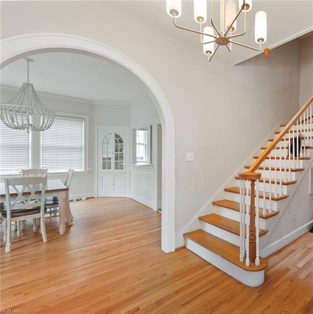 interior space featuring crown molding, hardwood / wood-style flooring, and a chandelier