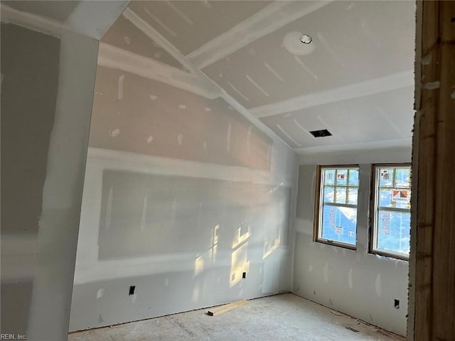 empty room featuring lofted ceiling