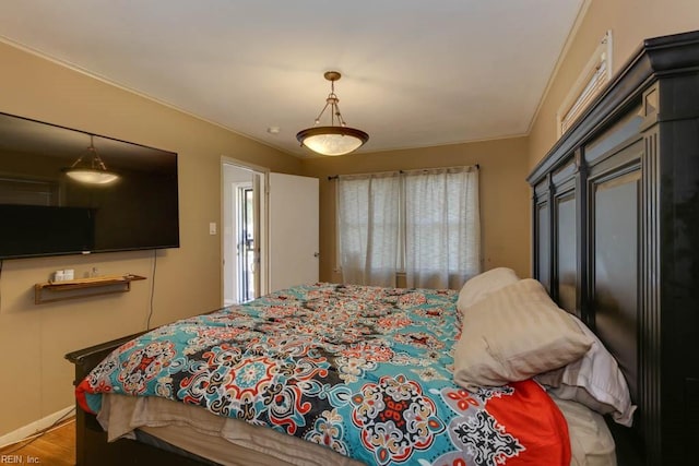 bedroom with crown molding and wood-type flooring