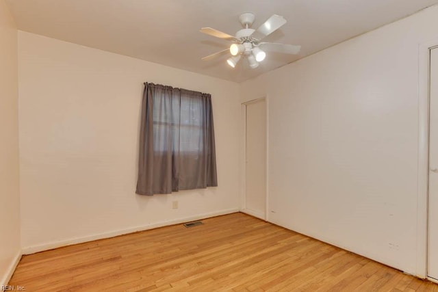 spare room with light wood-type flooring and ceiling fan