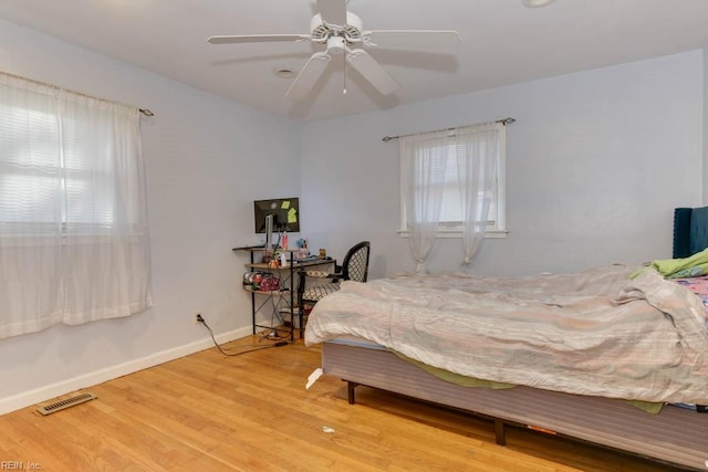 bedroom with ceiling fan and light wood-type flooring