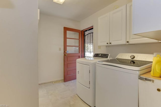 laundry area featuring cabinets and washing machine and clothes dryer