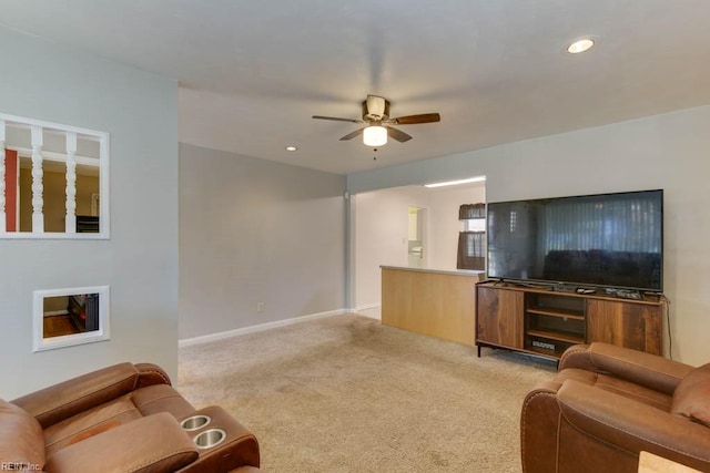 carpeted living room featuring ceiling fan