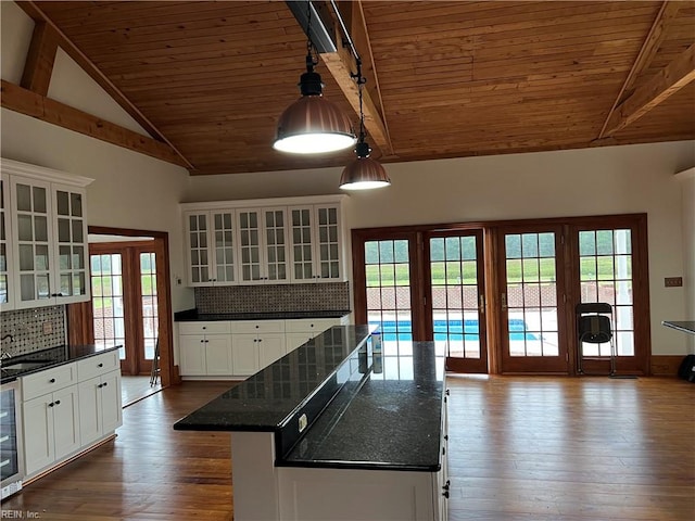 kitchen featuring wooden ceiling, white cabinetry, decorative light fixtures, and decorative backsplash