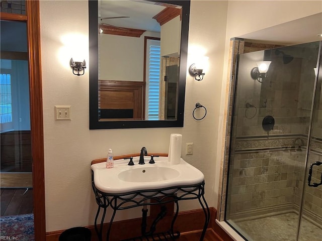 bathroom featuring hardwood / wood-style flooring, sink, and an enclosed shower