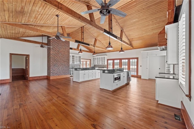 kitchen featuring hanging light fixtures, wooden ceiling, white cabinetry, and a kitchen island