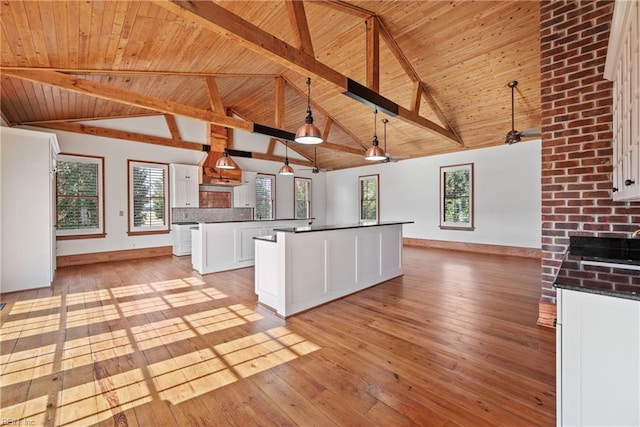 kitchen featuring pendant lighting, light wood-type flooring, white cabinetry, and a kitchen island