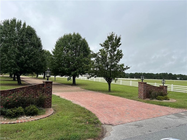 view of property's community featuring a yard and a rural view