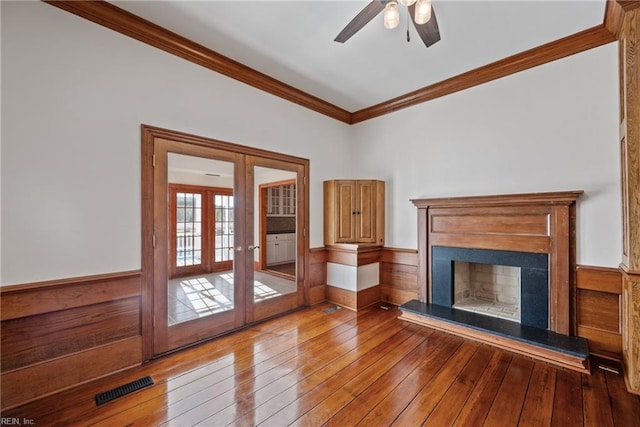 unfurnished living room featuring ornamental molding, french doors, light hardwood / wood-style flooring, and ceiling fan