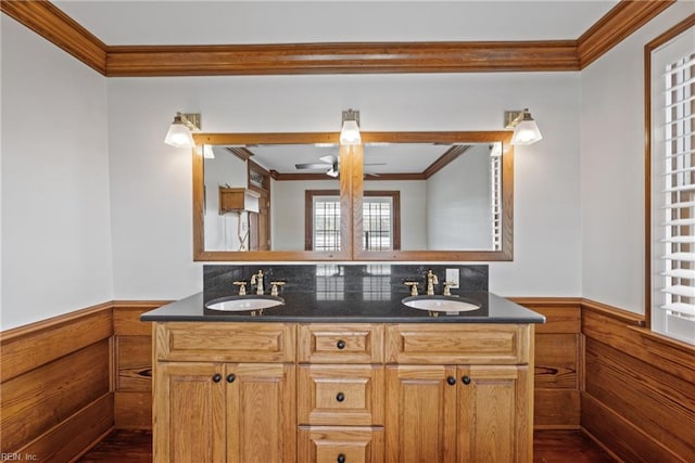 bathroom with vanity, wooden walls, and ornamental molding