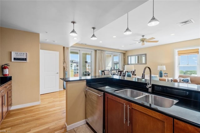 kitchen featuring hanging light fixtures, sink, stainless steel dishwasher, light hardwood / wood-style floors, and ceiling fan