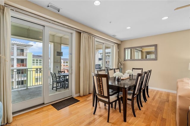 dining area featuring light wood-type flooring and plenty of natural light