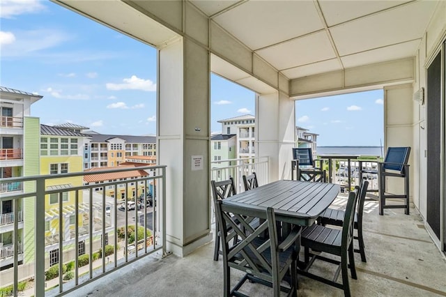 sunroom featuring a healthy amount of sunlight and a water view