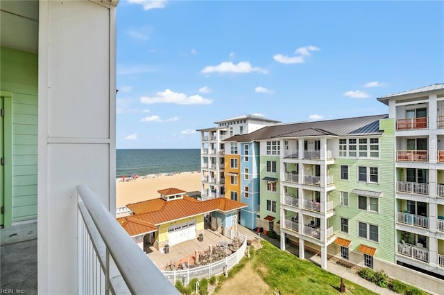 balcony featuring a water view and a beach view