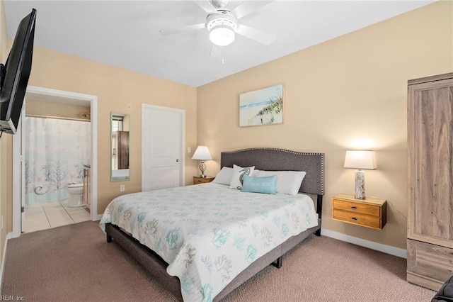 carpeted bedroom featuring connected bathroom and ceiling fan