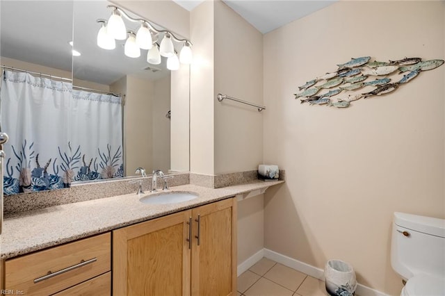 bathroom featuring toilet, vanity, and tile patterned floors