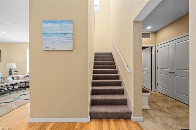 stairway with hardwood / wood-style floors