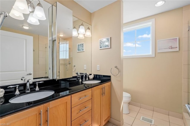 bathroom with vanity, tile patterned flooring, toilet, and an enclosed shower