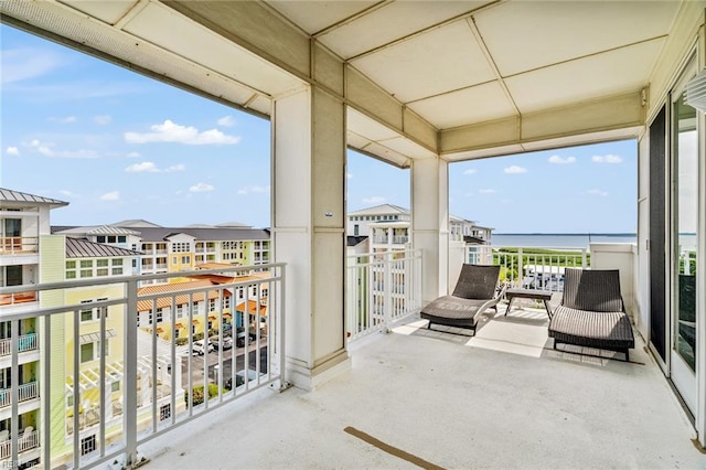 sunroom / solarium featuring a water view