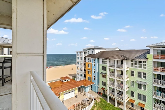 balcony featuring a water view and a view of the beach