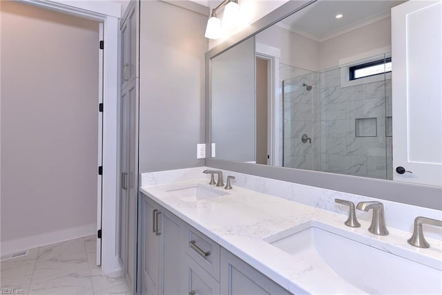 bathroom featuring crown molding, a sink, marble finish floor, and tiled shower