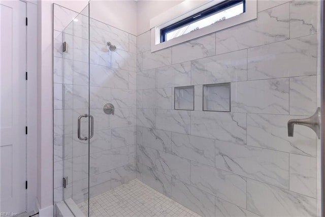 bathroom with a shower with shower door