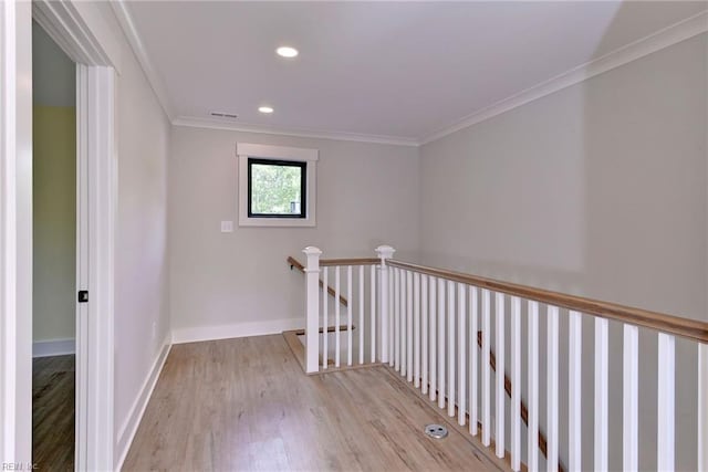 hall featuring ornamental molding and light wood-type flooring