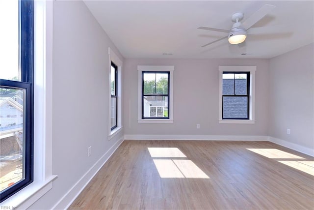 empty room with light hardwood / wood-style floors and ceiling fan