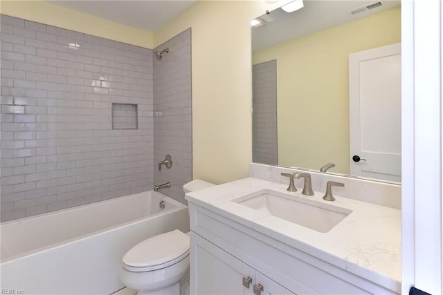 full bathroom with vanity, toilet, and tiled shower / bath