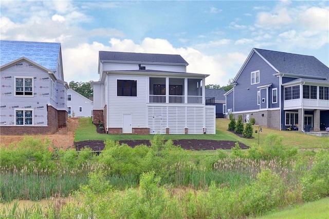 rear view of property with a sunroom